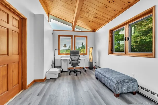 a kitchen with white cabinets stainless steel appliances and wooden floor