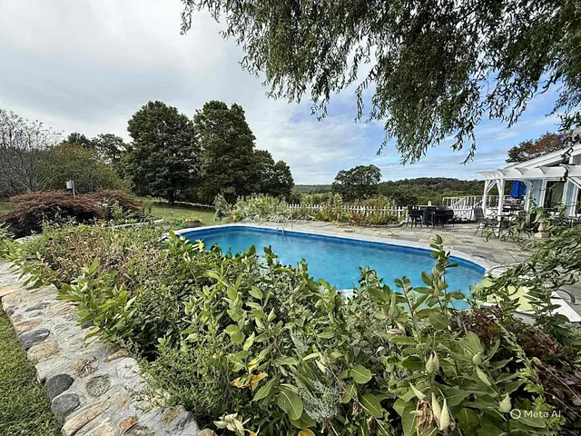 a view of a swimming pool with an outdoor space and seating area