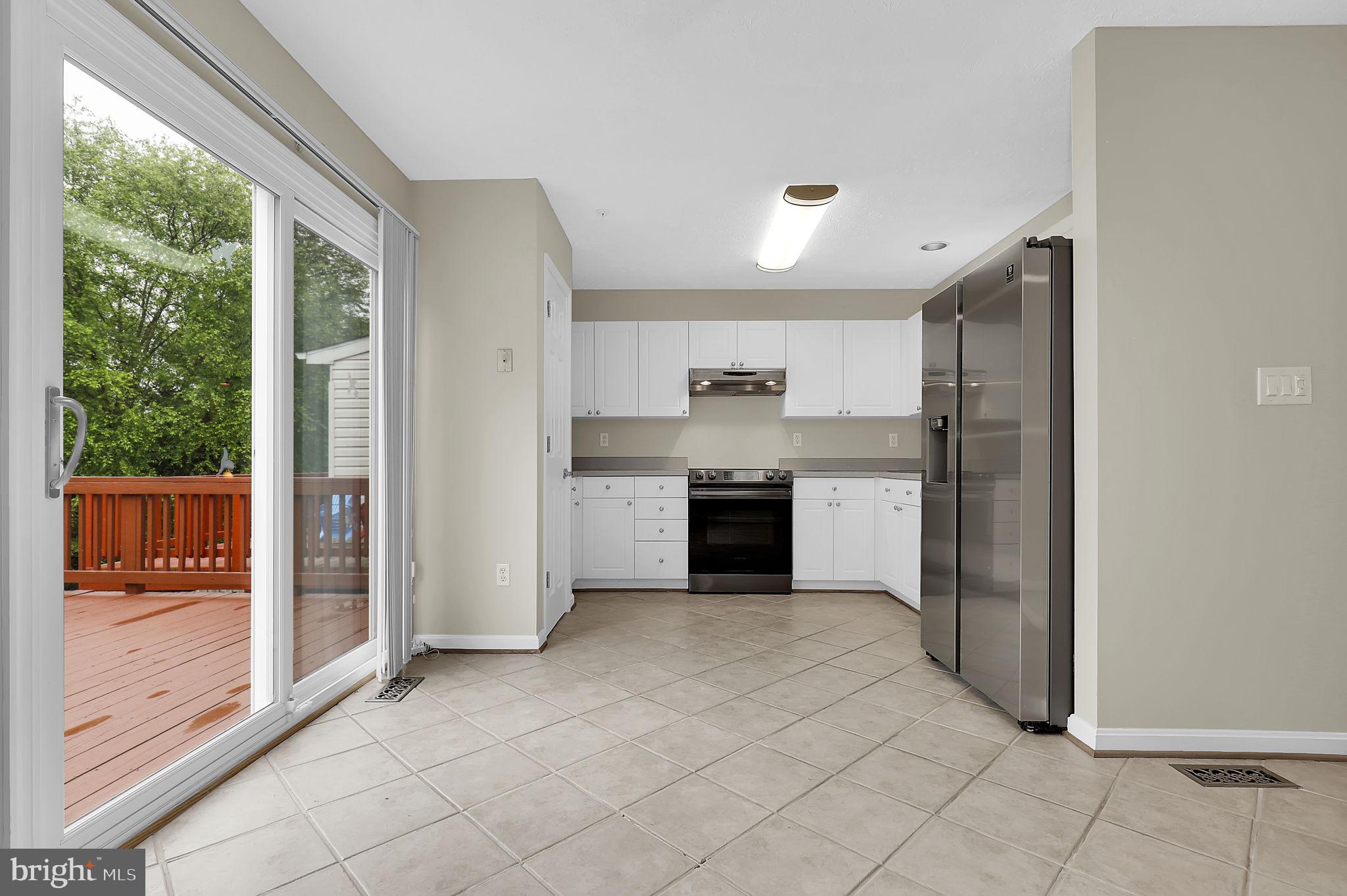 7150 Natures Road Columbia, MD 21046 - Photo 11 of 45 a kitchen with stainless steel appliances granite countertop a refrigerator and a sink