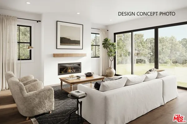 a living room with furniture fireplace and a large window