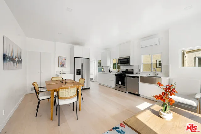 a view of a dining room with furniture and a kitchen