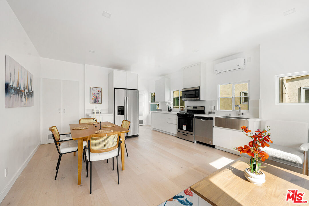 117 West Channel Road, Unit 117 Santa Monica, CA 90402 - Photo 2 of 6 a view of a dining room with furniture and a kitchen