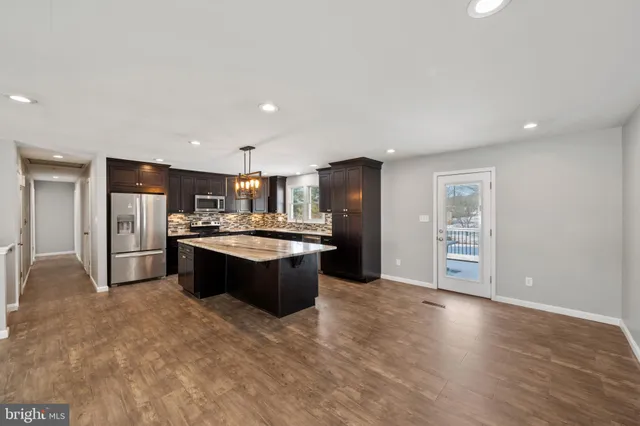 a view of a balcony with wooden floor and outdoor seating