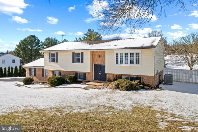 a view of a house with a yard and sitting area