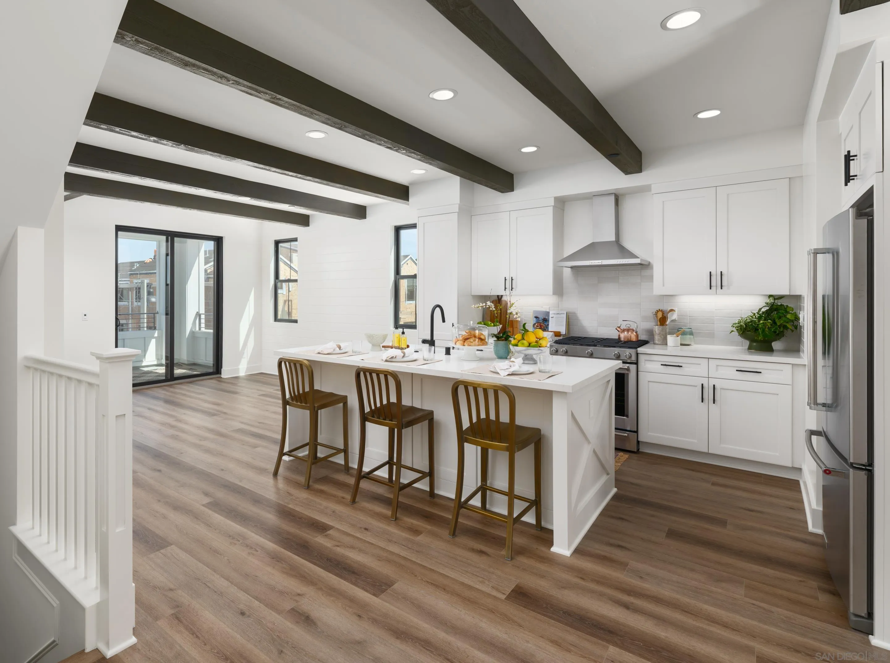 1301 Bergamo Place, Unit 101 Encinitas, CA 92024 - Photo 1 of 43 a kitchen that has a lot of cabinets in it with stainless steel appliances granite countertop a stove a sink and a refrigerator