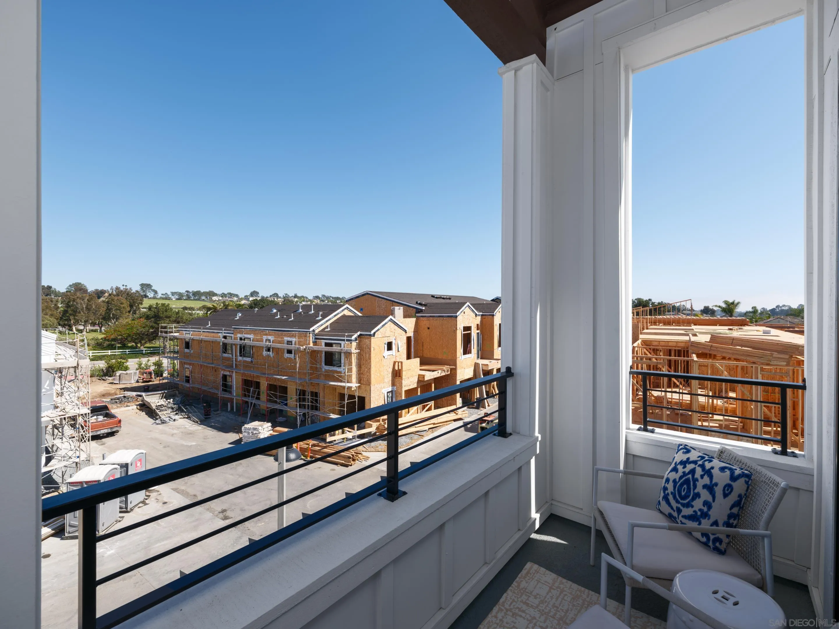 1301 Bergamo Place, Unit 101 Encinitas, CA 92024 - Photo 15 of 43 a view of a balcony with two chairs and a potted plant