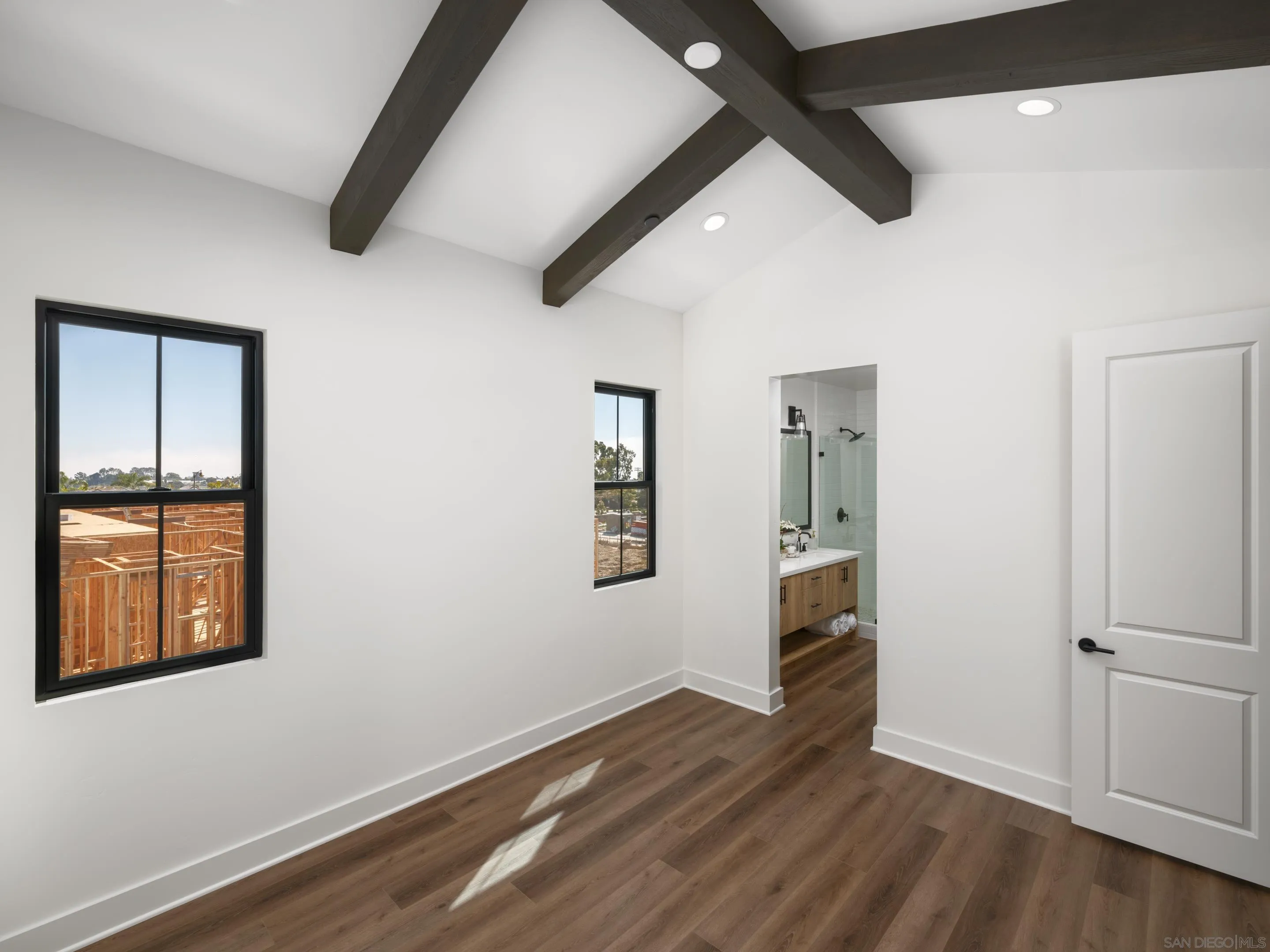 1301 Bergamo Place, Unit 101 Encinitas, CA 92024 - Photo 16 of 43 an empty room with wooden floor and windows