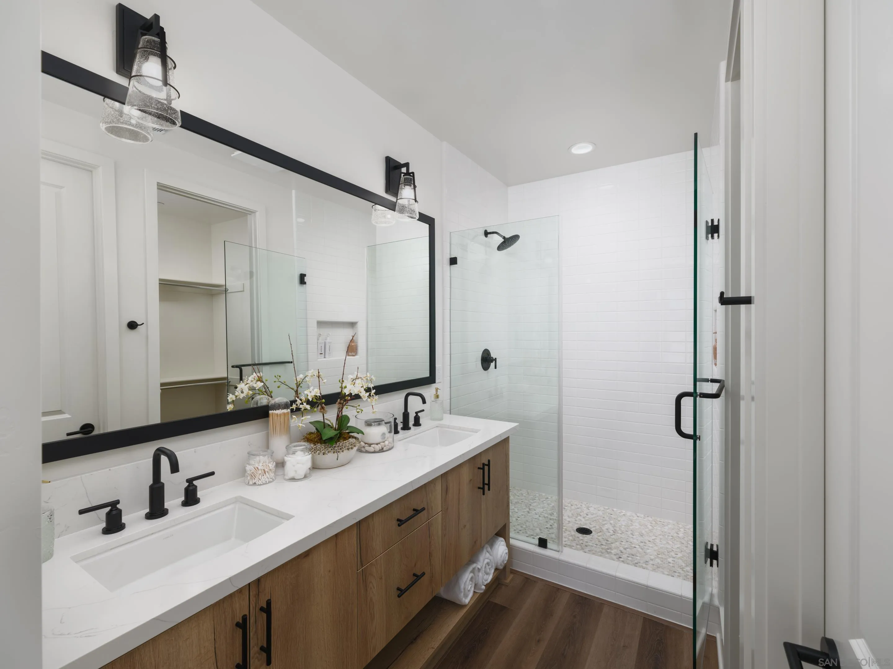 1301 Bergamo Place, Unit 101 Encinitas, CA 92024 - Photo 17 of 43 a bathroom with double vanity sink and mirror