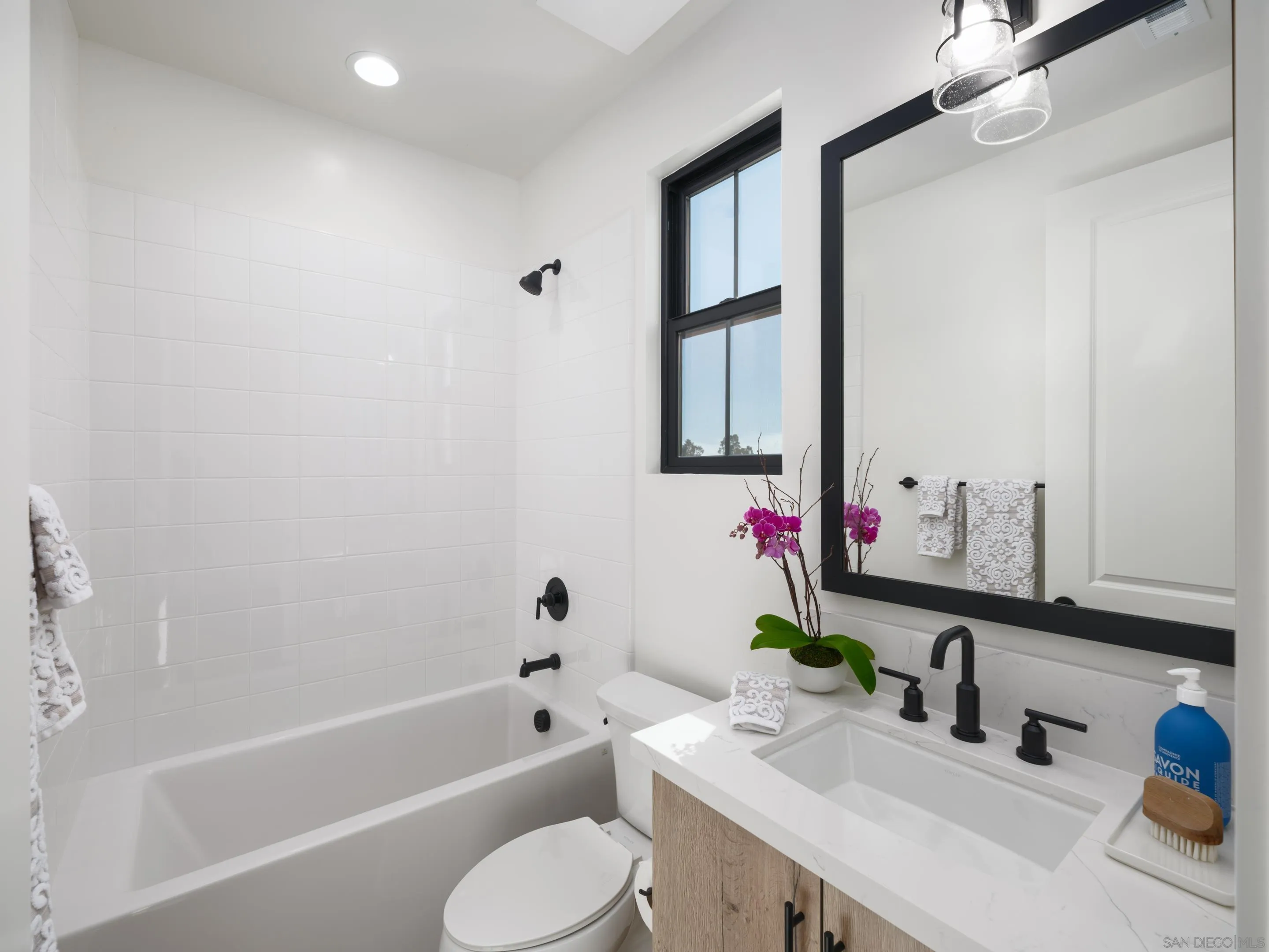 1301 Bergamo Place, Unit 101 Encinitas, CA 92024 - Photo 20 of 43 a bathroom with a bathtub sink vanity mirror and toilet