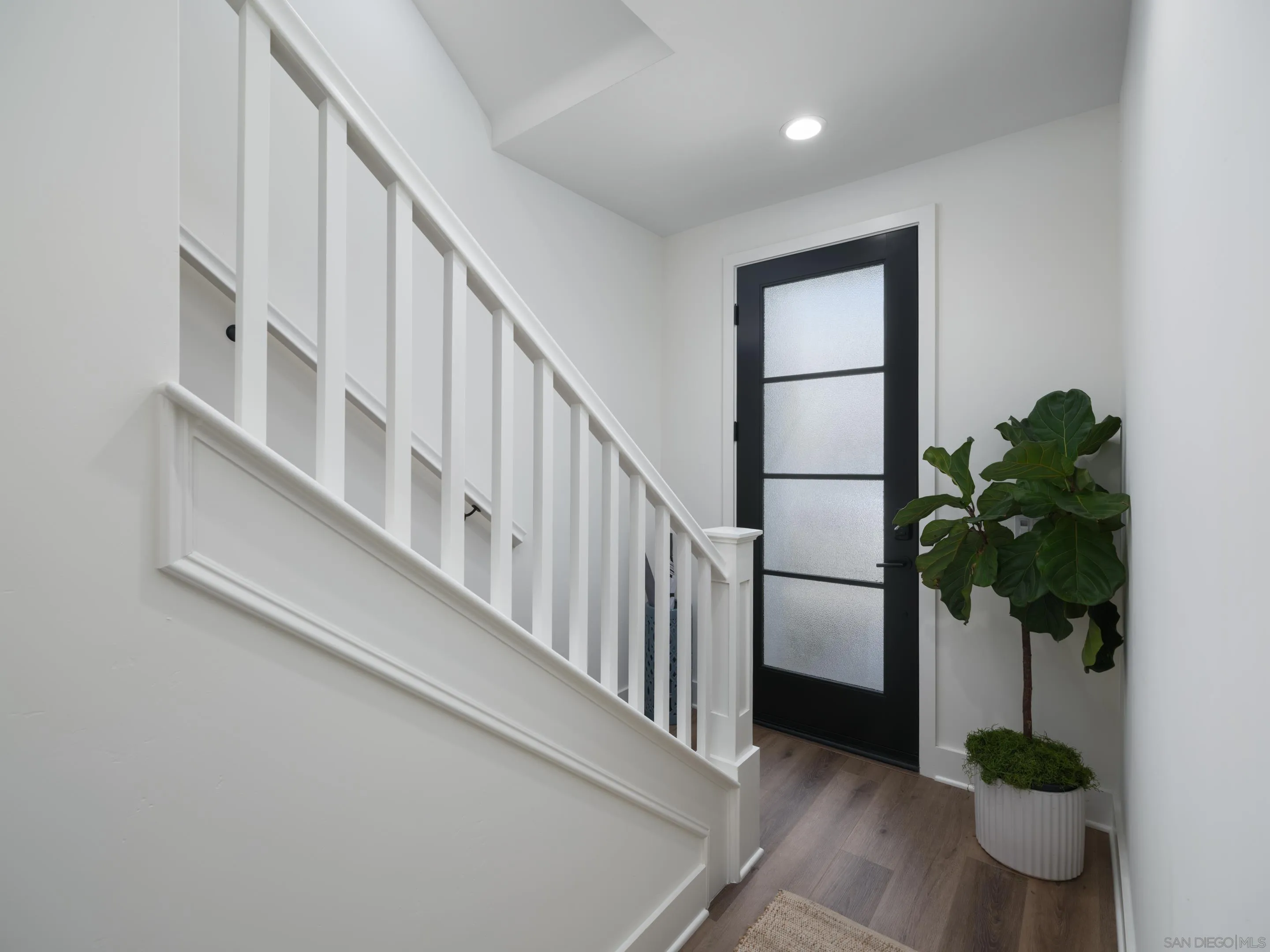 1301 Bergamo Place, Unit 101 Encinitas, CA 92024 - Photo 23 of 43 a view of staircase with white walls and potted plant