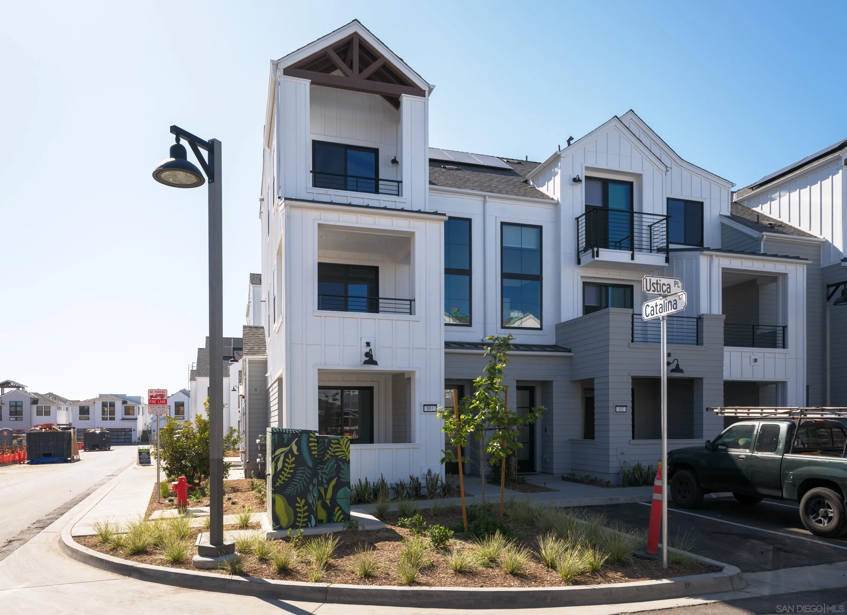 1301 Bergamo Place, Unit 101 Encinitas, CA 92024 - Photo 3 of 43 a front view of a house with a yard