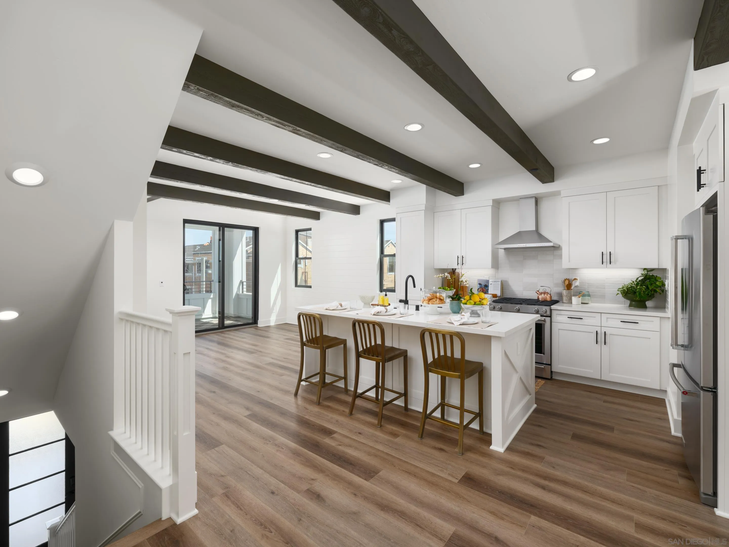 1301 Bergamo Place, Unit 101 Encinitas, CA 92024 - Photo 6 of 43 a open kitchen with white cabinets and wooden floor