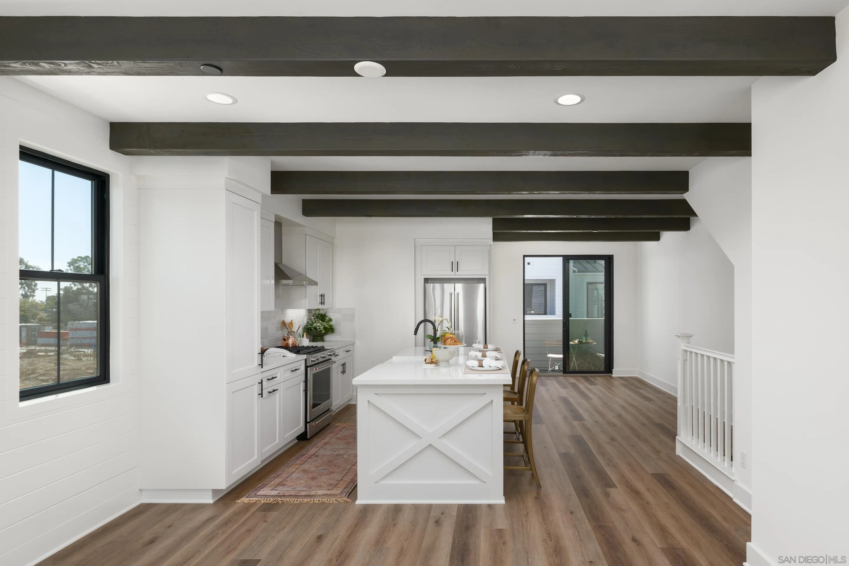 1301 Bergamo Place, Unit 101 Encinitas, CA 92024 - Photo 7 of 43 a hallway with a stove a microwave and furniture