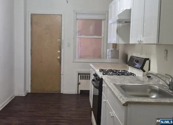a kitchen with a stove and a refrigerator