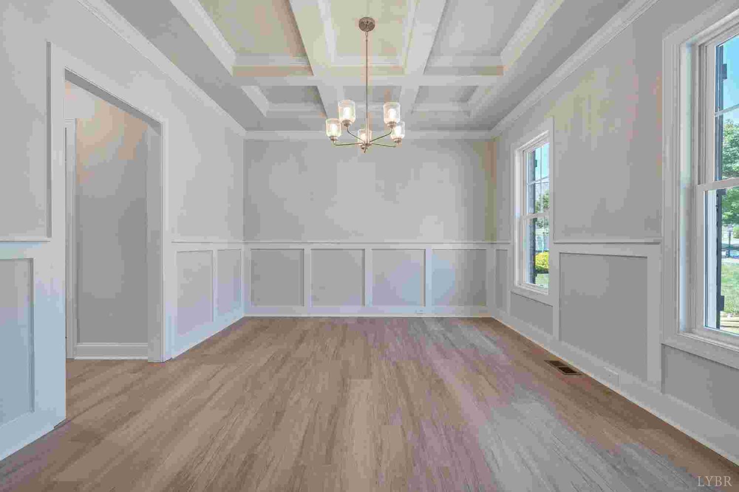 80 Shotman Road Rustburg, VA 24588 - Photo 2 of 23 an empty room with wooden floor door and windows