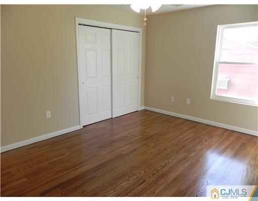 5 Eastlick Road Edison, NJ 08817 - Photo 14 of 16 an empty room with wooden floor and windows