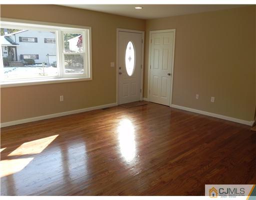 5 Eastlick Road Edison, NJ 08817 - Photo 4 of 16 an empty room with wooden floor and windows