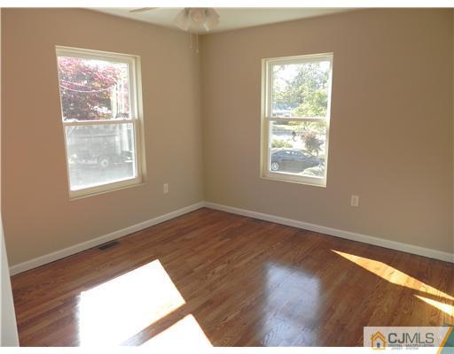 5 Eastlick Road Edison, NJ 08817 - Photo 6 of 16 an empty room with wooden floor and windows