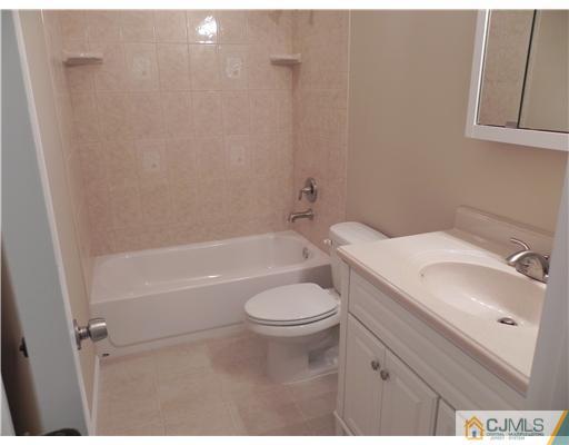 5 Eastlick Road Edison, NJ 08817 - Photo 7 of 16 a bathroom with a granite countertop toilet a sink and bathtub