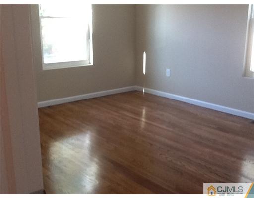 5 Eastlick Road Edison, NJ 08817 - Photo 9 of 16 a view of an empty room with wooden floor