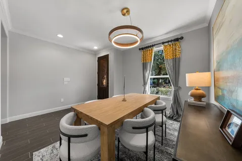 a view of a dining room with furniture window and wooden floor