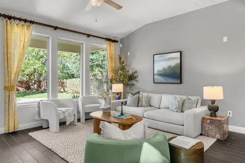 a living room with furniture and a large window