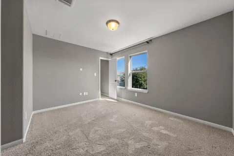 a view of an empty room with a cabinet