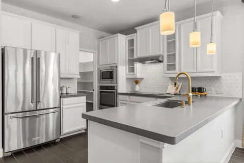 a kitchen with stainless steel appliances a refrigerator stove and microwave