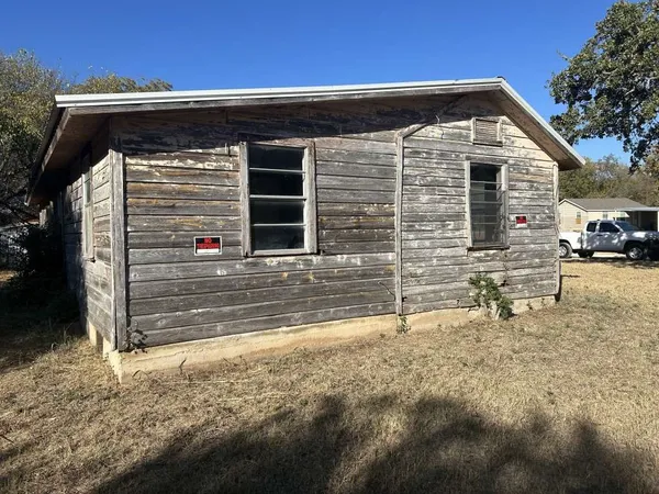 a view of house with backyard of house