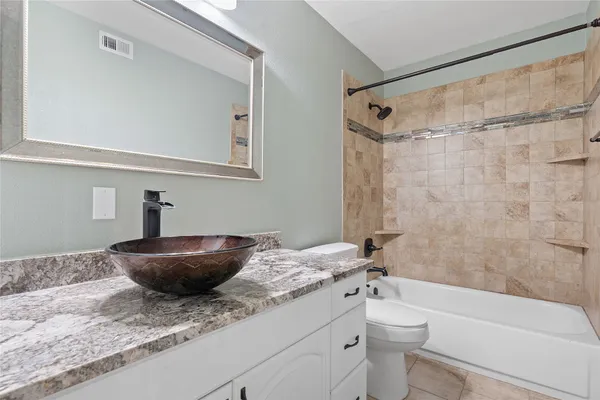 a kitchen with kitchen island granite countertop a stove top oven a sink and stainless steel appliances