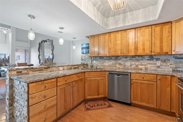 a kitchen with cabinets and wooden floor