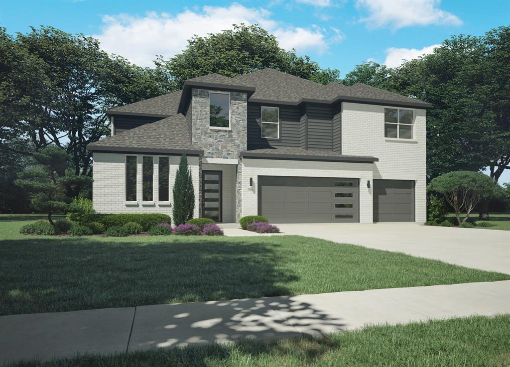 a front view of a house with a garden and yard