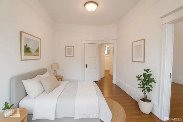 a bed room with a bed and a potted plant