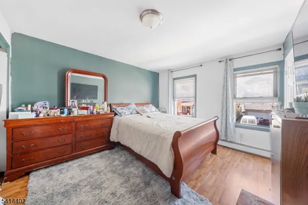 a bed room with a bed window and mirror