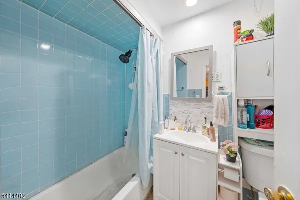 a bathroom with a sink vanity mirror and shower