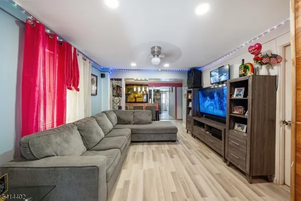 a living room with furniture a flat screen tv and a couch