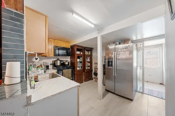 a kitchen with refrigerator and washer
