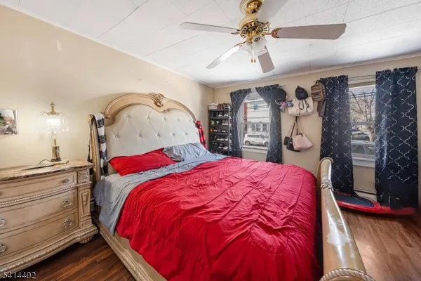 a bedroom with a bed and a dresser with the outer view