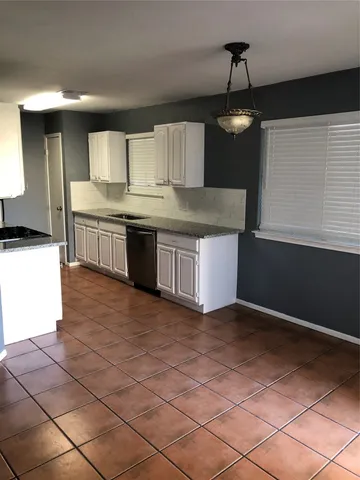 a kitchen with stainless steel appliances granite countertop a sink and a stove