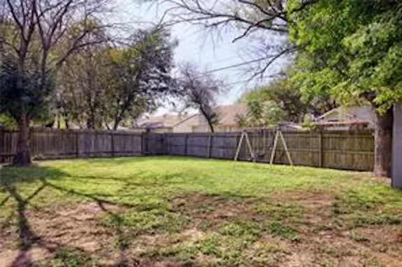 a view of a backyard with tree