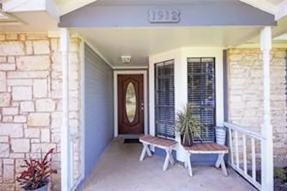 a view of a room with a large window and chair