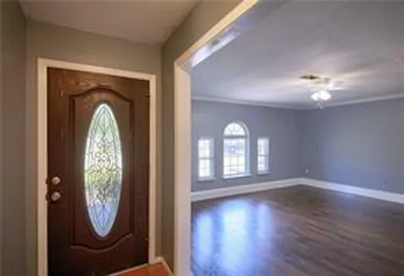 an empty room with mirror and furniture