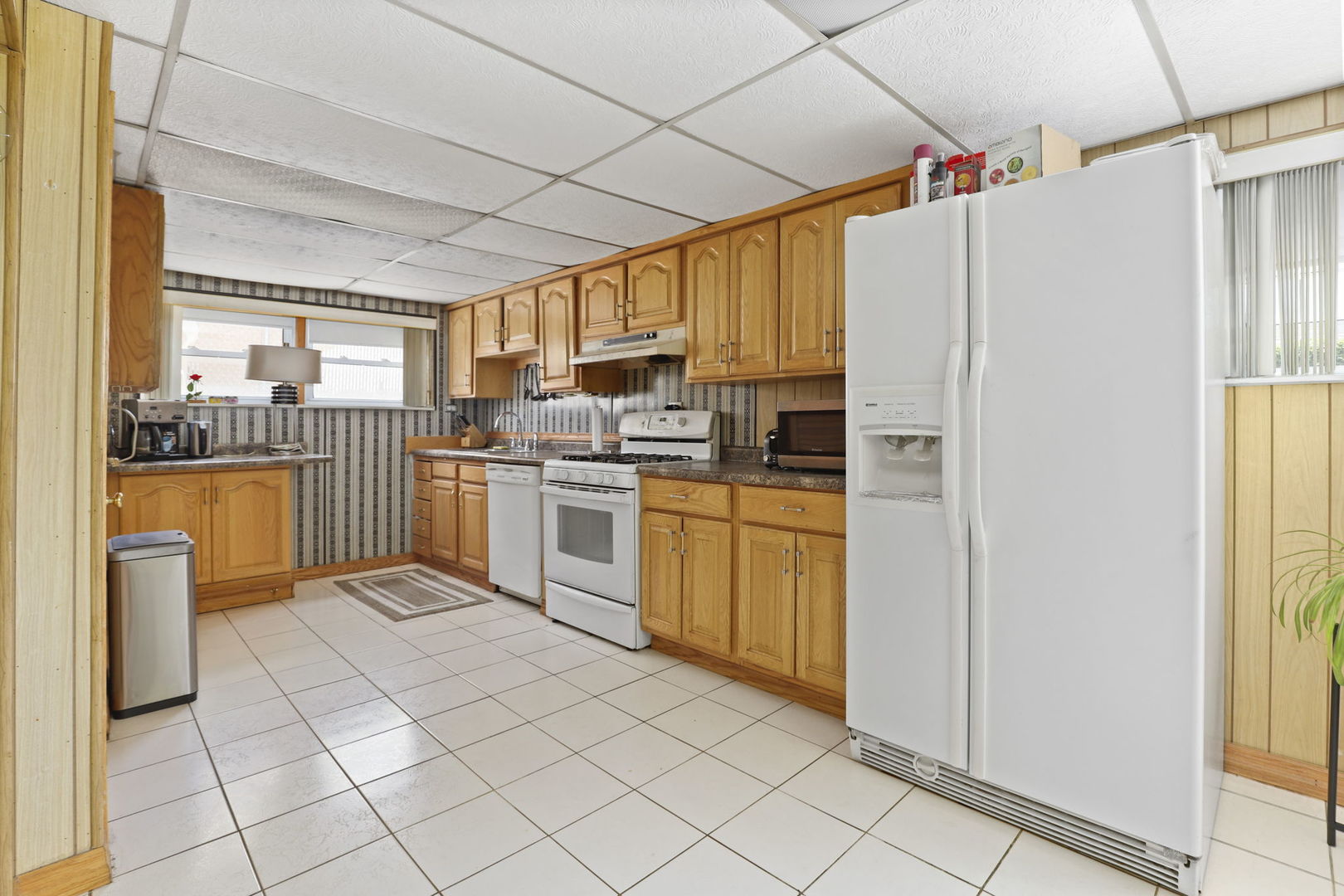3939 Bobby Lane Schiller Park, IL 60176 - Photo 21 of 26 a kitchen with cabinets and white appliances