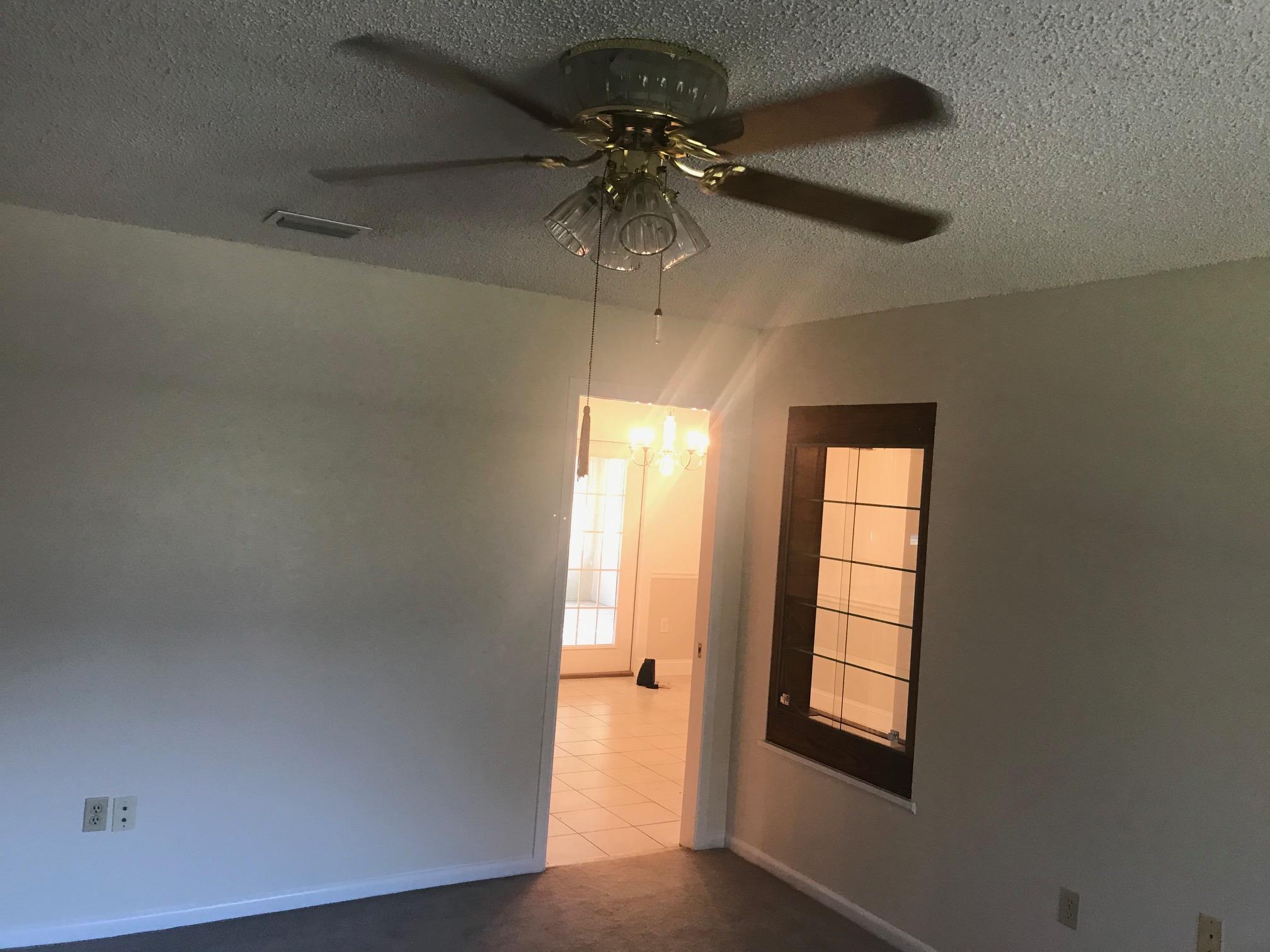 3606 Airport Road Crestview, FL 32539 - Photo 17 of 57 an empty room with windows and fan
