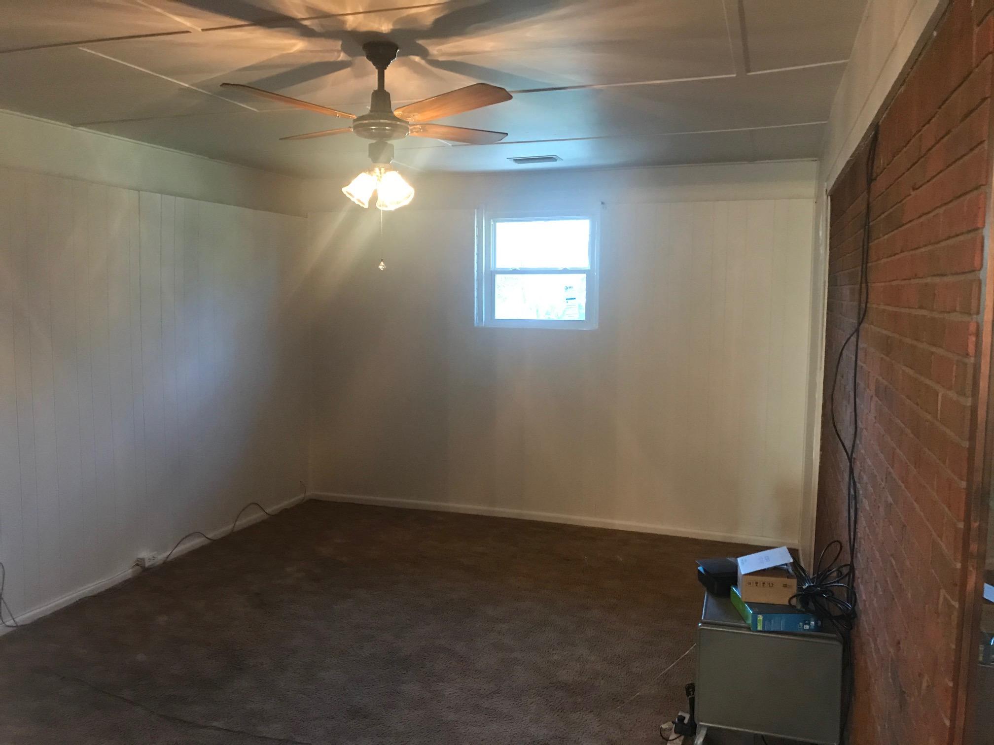 3606 Airport Road Crestview, FL 32539 - Photo 19 of 57 a room with a window and a chandelier fan