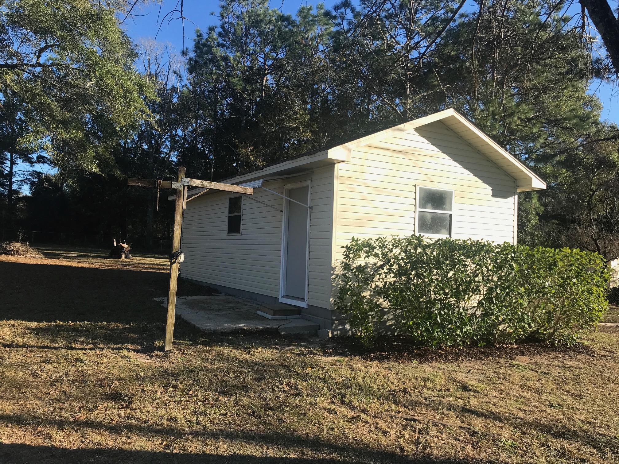 3606 Airport Road Crestview, FL 32539 - Photo 38 of 57 a backyard of a house with lots of green space