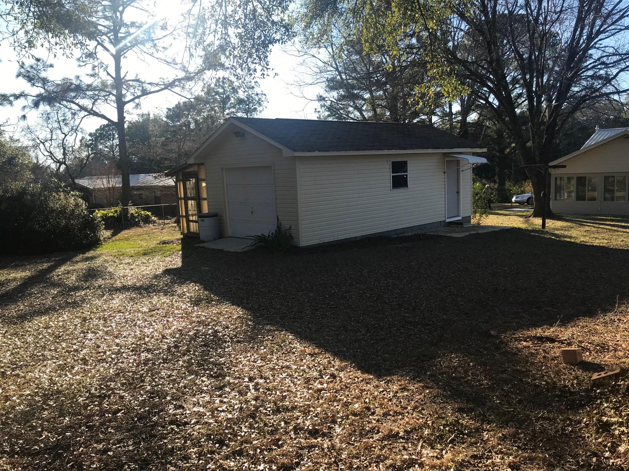 3606 Airport Road Crestview, FL 32539 - Photo 44 of 57 a view of a backyard with a large tree
