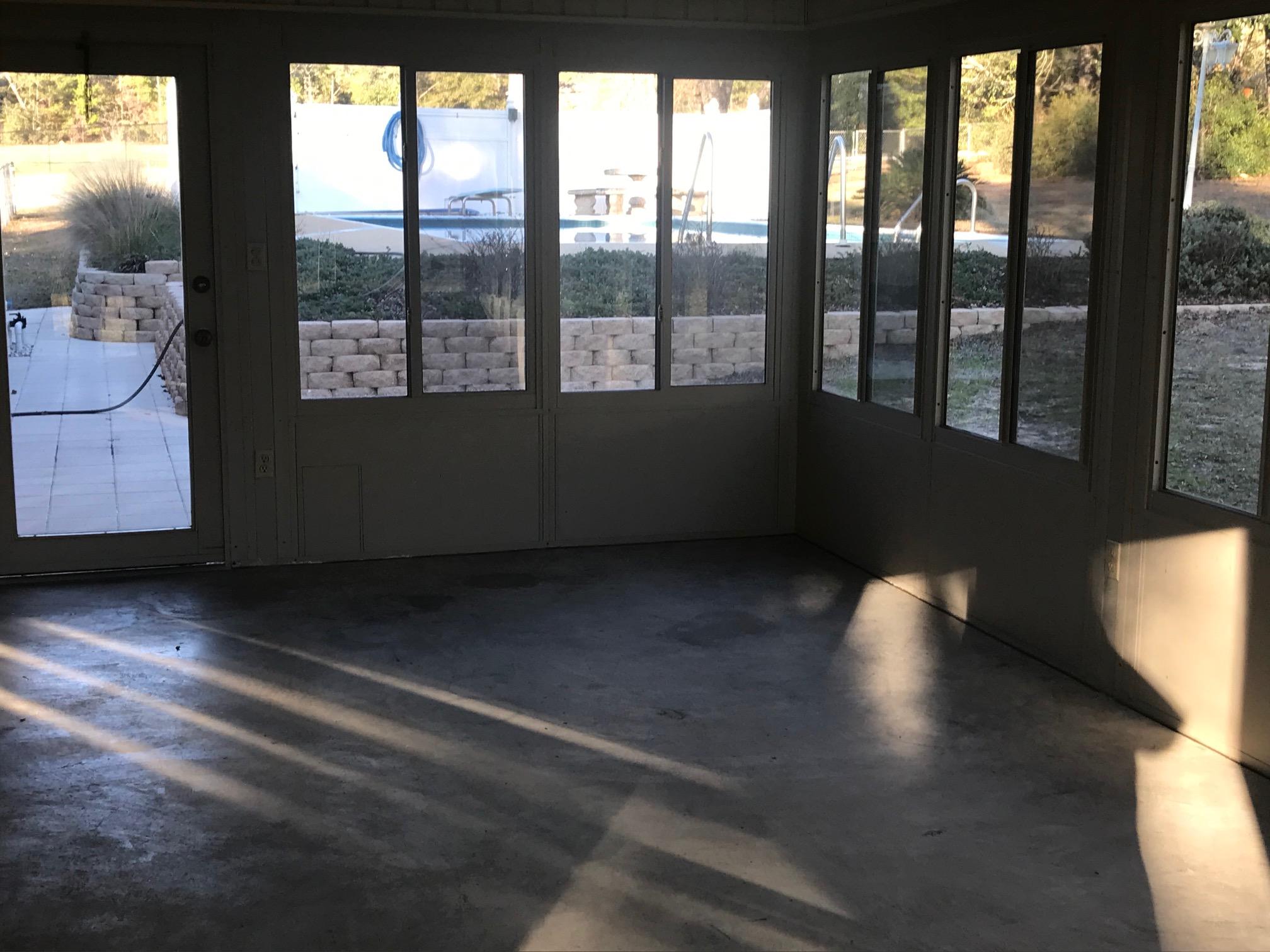 3606 Airport Road Crestview, FL 32539 - Photo 56 of 57 a view of an empty room with wooden floor and windows