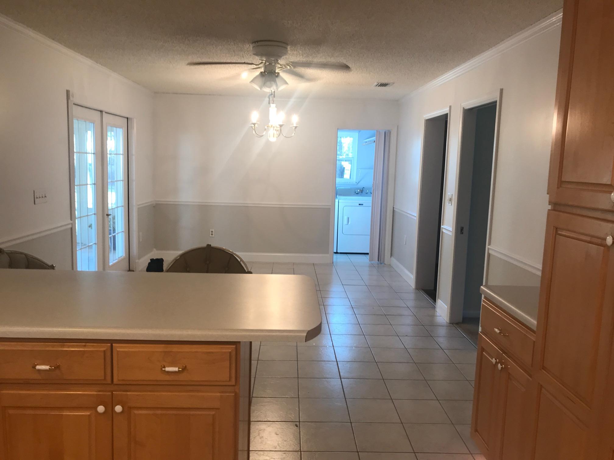3606 Airport Road Crestview, FL 32539 - Photo 6 of 57 a view of entryway with kitchen and chandelier