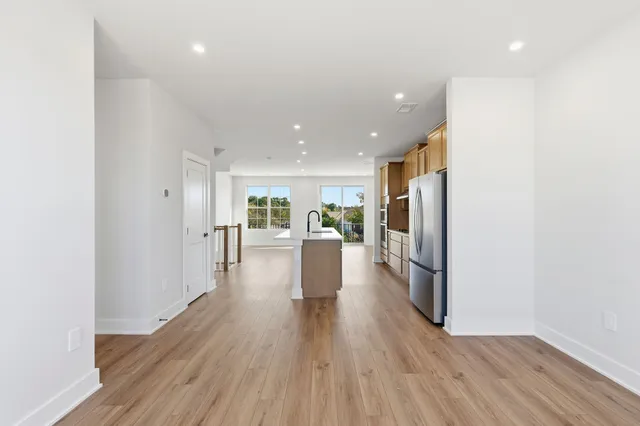 a view of a living room with wooden floor